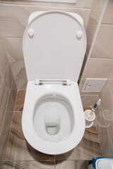 toilet in the small toilet room. ceramic tiles.