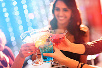 Toast to the weekend. Cropped shot of a group of women celebrating with cocktails at a party.