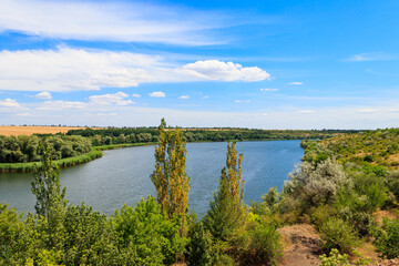 Obraz premium Summer landscape with beautiful river, green trees and blue sky
