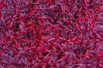 Naklejka premium Background and texture of raw fresh grated red beetroot vegetable