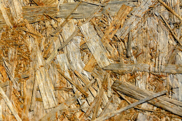 The texture of a wood-fiber board burnt out in the sun.