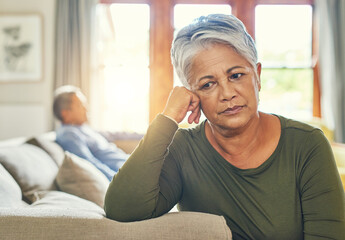 Im growing tired of this. Shot of a senior couple sitting separately on a couch after having an...
