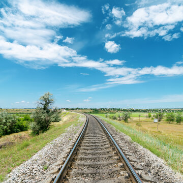 Railway In Green Landscape And White Clouds In Blue Sky