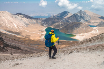 a mountaineer contemplating the volcanic lakes of the crater of the Nevado de Toluca in Mexico
