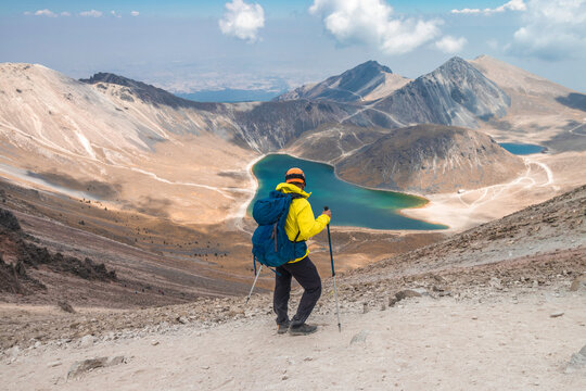 a mountaineer contemplating the volcanic lakes of the crater of the Nevado de Toluca in Mexico