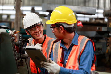Asian male engineer team monitors and control Planning for maintenance of metalworking machines in industrial plants,