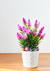 Vertical view of small Easter eggs and decorative flowers. Background with copy space. Selective focus. Happy Easter.