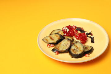Concept of tasty food with grilled banana on orange background