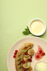 Concept of tasty food with grilled banana on green background