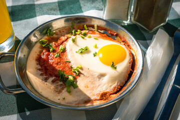 Shakshuka (sunny side up egg in traditional sauce) for Israeli breakfast. Food background.