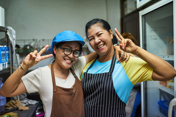 Kitchen buddies. Portrait of two happy cooks posing together in the kitchen.