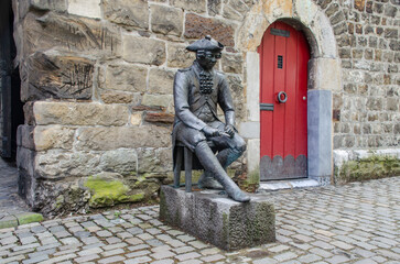 Aachen May 2021: Figure of a carving "Pennsoldier" in bronze by Klaus Gehlen, 2007. Location: in front of the Marschiertor in Aachen, side towards the city