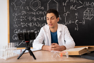 Arab chemist blogger writing blog video, teaching videos for students of chemistry, science and online education