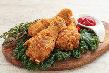 Fried chicken drumsticks with tomato sauce