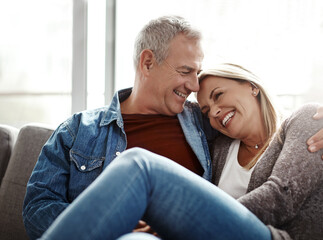 Days well spent bring a life of content. Shot of an affectionate mature couple relaxing together on the sofa at home.