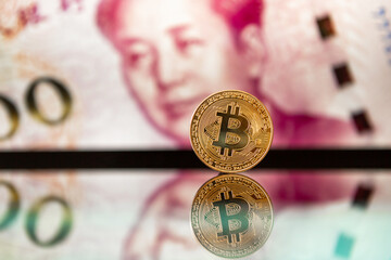 Chinese money and bitcoin in the background