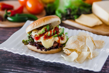 mexican burger with chips and avocado on table food with ingredients in Mexico
