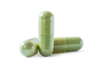 herb capsule with green herbal on white background.