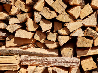 Chopped oak firewood neatly stacked. Alternative fuel.
