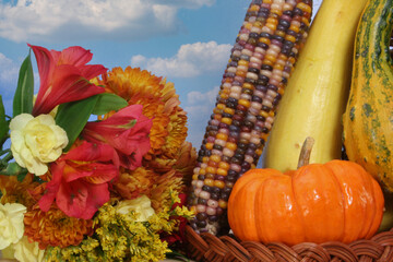 Cornucopia With Fall Vegetables and Flowers on Blue Sky Background