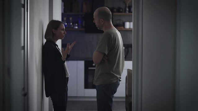 Violent quarrel in the family. Domestic conflict, husband and wife swear and yell at each other.