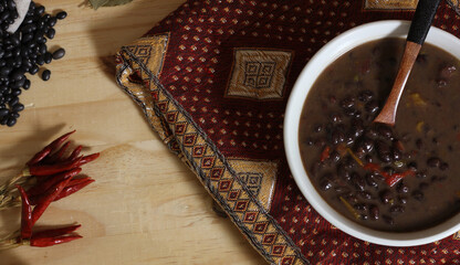 Black Bean Chili on Wooden Table With Spices and Dried Black Beans