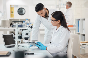 Sharing viewpoints on the days discoveries. Shot of two scientists working together in a lab. - obrazy, fototapety, plakaty