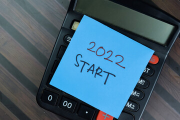 2022 Start write on sticky notes isolated on Wooden Table.