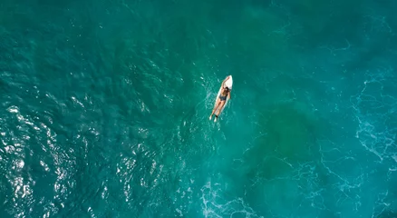 Fototapeten Aerial view of the ocean and surfer girl. © Dima Anikin