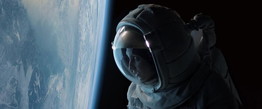 CU Portrait of Caucasian female astronaut during spacewalk on the Earth orbit. Space exploration, Mars mission. Shot with 2x anamorphic lens