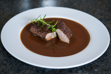 ready to eat, grilled game meat from the roe deer with brown sauce and rosemary