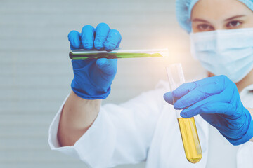 Scientist in uniform holding beaker and test tube have chemical liquid for testing chemical reaction.