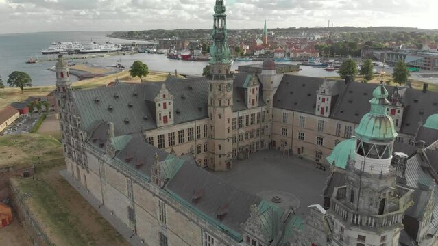 Cinematic 4K aerial drone bird's-eye view of Kronborg Slot Castle, one of UNESCO's World Heritage sites, Helsing&oslash;r city and Marina in in Denmark