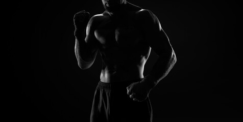 Fototapeta na wymiar Noname image of a kickboxer on a dark background. The concept of mixed martial arts.