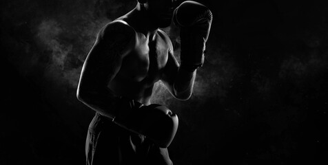 Noname image of a kickboxer on a dark background. The concept of mixed martial arts. - obrazy, fototapety, plakaty
