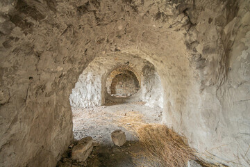 Old dark brick arched abandoned fortification tunnel of the 18 th century.