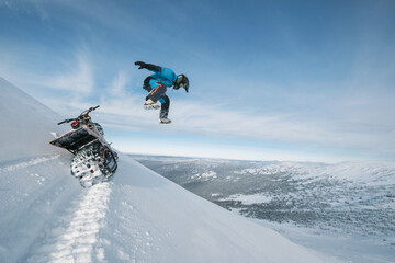 Snowbike rider on steep snowy slope. Modify motorcycle with ski and special snowmobile-style track instead of wheels