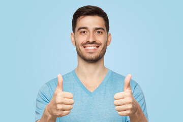 Young happy man showing thumbs up
