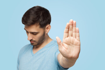 Young man showing stop gesture with hand