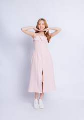 Naklejka premium Full length image of young Asian woman wearing dress on white background