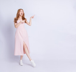 Full length image of young Asian woman wearing dress on white background