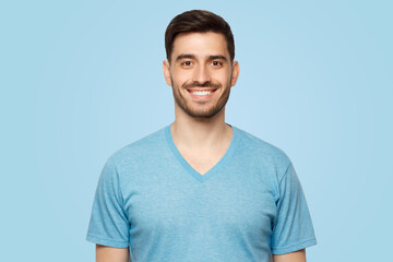 Obraz premium Close-up portrait of young smiling handsome male with short dark hair and stubble