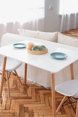 White table. Serving on the table. View from above. parquet.