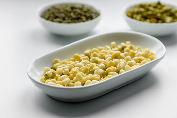 Organics fresh Baby Green Bean Sprouts in white ceramic bowl on a dark concrete background