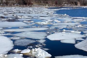 ice floes on the surface of the river in early spring, ice drift, melting snow