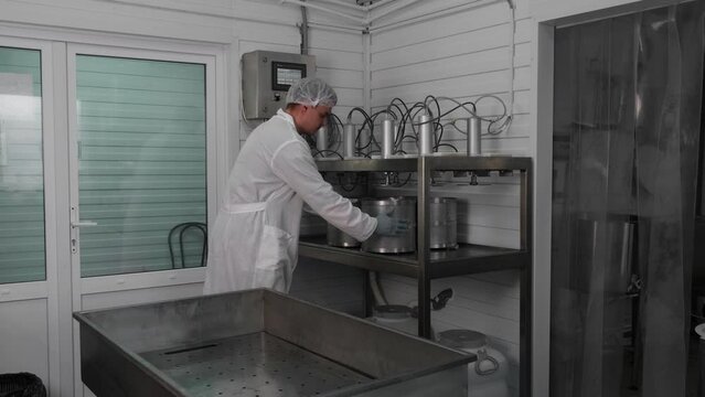 Cheese engineer removes cheese from the press