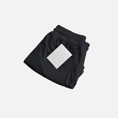 Fototapeta premium Mockup of black folded shorts with compression lining, price tag near pocket, front view.