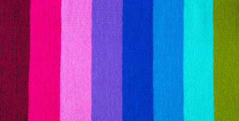 multi colored background. knitted wool fabric texture with stripes