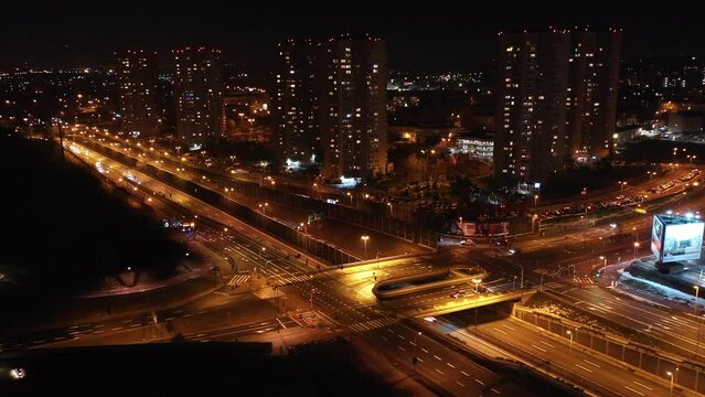 Aerial view of Housing estate in Katowice called Stars and the road intersection on the DTŚ Highway in foreground - Day to night transition. Silesia, Poland.
