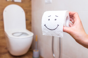 close-up of toilet paper with drawn happy face, concept of health, hygiene